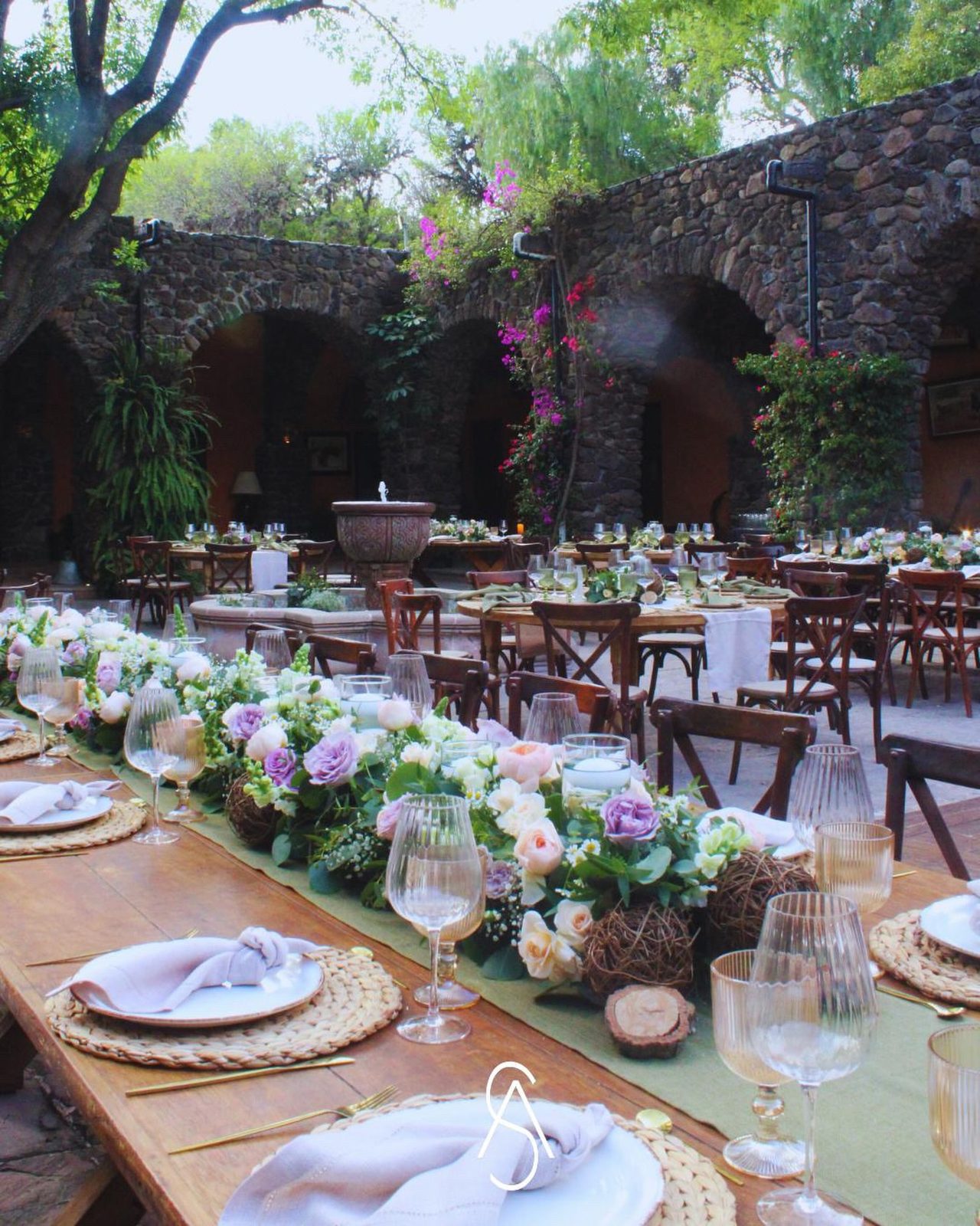 Mesa imperial de banquete en el patio de arcos de piedra de Hacienda Dolores, montajes para eventos en Querétaro